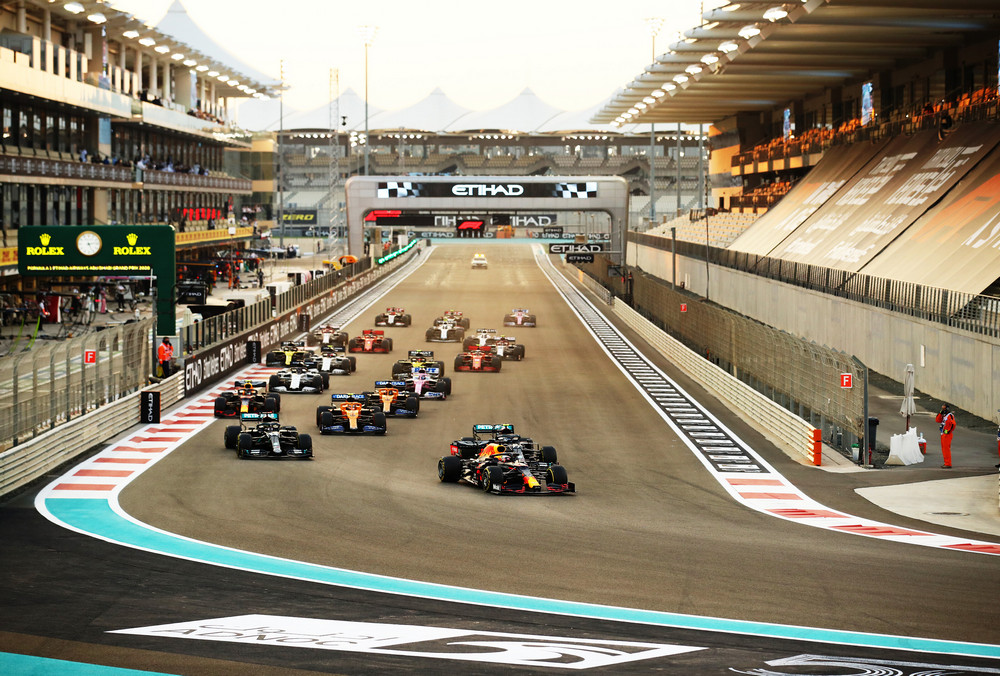 ABU DHABI, UNITED ARAB EMIRATES - DECEMBER 13: Max Verstappen of the Netherlands driving the (33) Aston Martin Red Bull Racing RB16 leads Lewis Hamilton of Great Britain driving the (44) Mercedes AMG Petronas F1 Team Mercedes W11 and Valtteri Bottas of Finland driving the (77) Mercedes AMG Petronas F1 Team Mercedes W11 into turn one at the start during the F1 Grand Prix of Abu Dhabi at Yas Marina Circuit on December 13, 2020 in Abu Dhabi, United Arab Emirates. (Photo by Bryn Lennon/Getty Images) // Getty Images / Red Bull Content Pool // SI202012130392 // Usage for editorial use only //