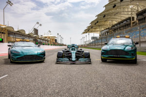 An Aston Martin Vantage safety car, Aston Martin AMR21 and Aston Martin DBX line-up on the grid