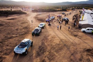 CAPO TEULADA, SARDINIA, ITALY - OCTOBER 22: Jutta Kleinschmidt (GER)/Mattias Ekstrom (SWE), ABT CUPRA XE, leads Emma Gilmour (NZL)/Stephane Sarrazin (FRA), Veloce Racing, and Mikaela Ahlin-Kottulinsky (SWE)/Kevin Hansen (SWE), JBXE Extreme-E Team, onto the course during the Island X Prix on October 22, 2021 in Capo Teulada, Sardinia, Italy. (Photo by Charly Lopez / LAT Images)
