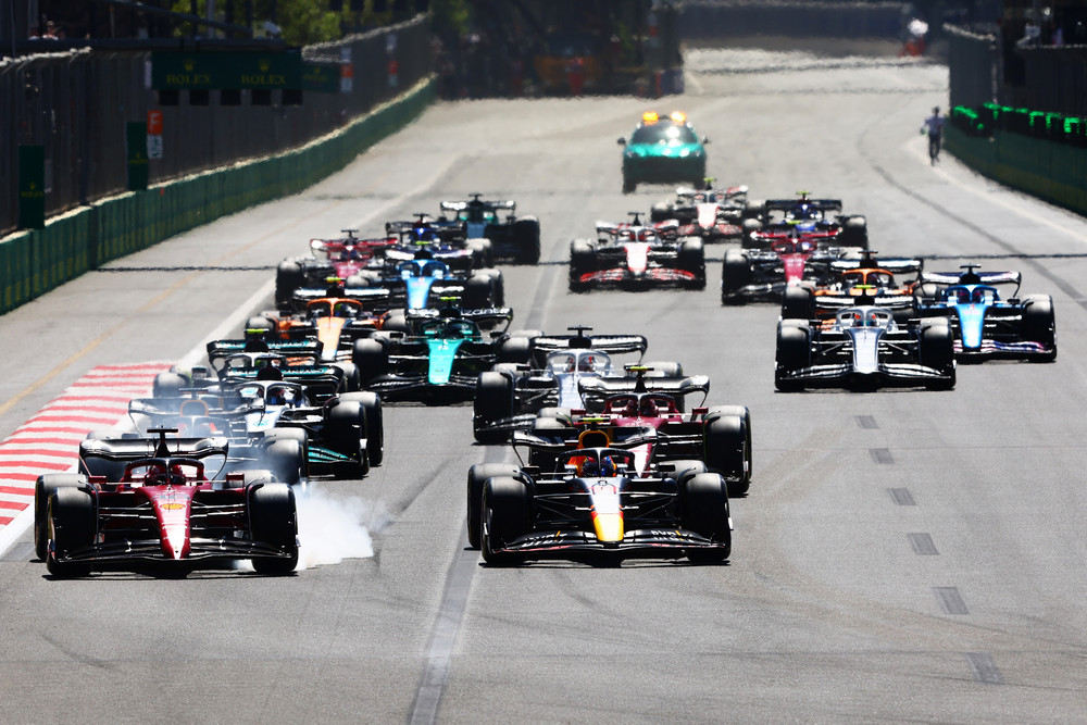 BAKU, AZERBAIJAN - JUNE 12: Charles Leclerc of Monaco driving the (16) Ferrari F1-75 locks a wheel under braking as he battle for track position with Sergio Perez of Mexico driving the (11) Oracle Red Bull Racing RB18 at the start during the F1 Grand Prix of Azerbaijan at Baku City Circuit on June 12, 2022 in Baku, Azerbaijan. (Photo by Mark Thompson/Getty Images) // Getty Images / Red Bull Content Pool // SI202206120229 // Usage for editorial use only //