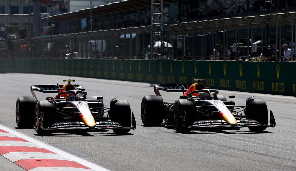 BAKU, AZERBAIJAN - JUNE 12: Max Verstappen of the Netherlands driving the (1) Oracle Red Bull Racing RB18 overtakes Sergio Perez of Mexico driving the (11) Oracle Red Bull Racing RB18 for the lead during the F1 Grand Prix of Azerbaijan at Baku City Circuit on June 12, 2022 in Baku, Azerbaijan. (Photo by Peter Fox/Getty Images) // Getty Images / Red Bull Content Pool // SI202206120280 // Usage for editorial use only //