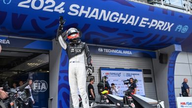 Mitch Evans, Jaguar TCS Racing, 1st position, stands on his car in Parc Ferme