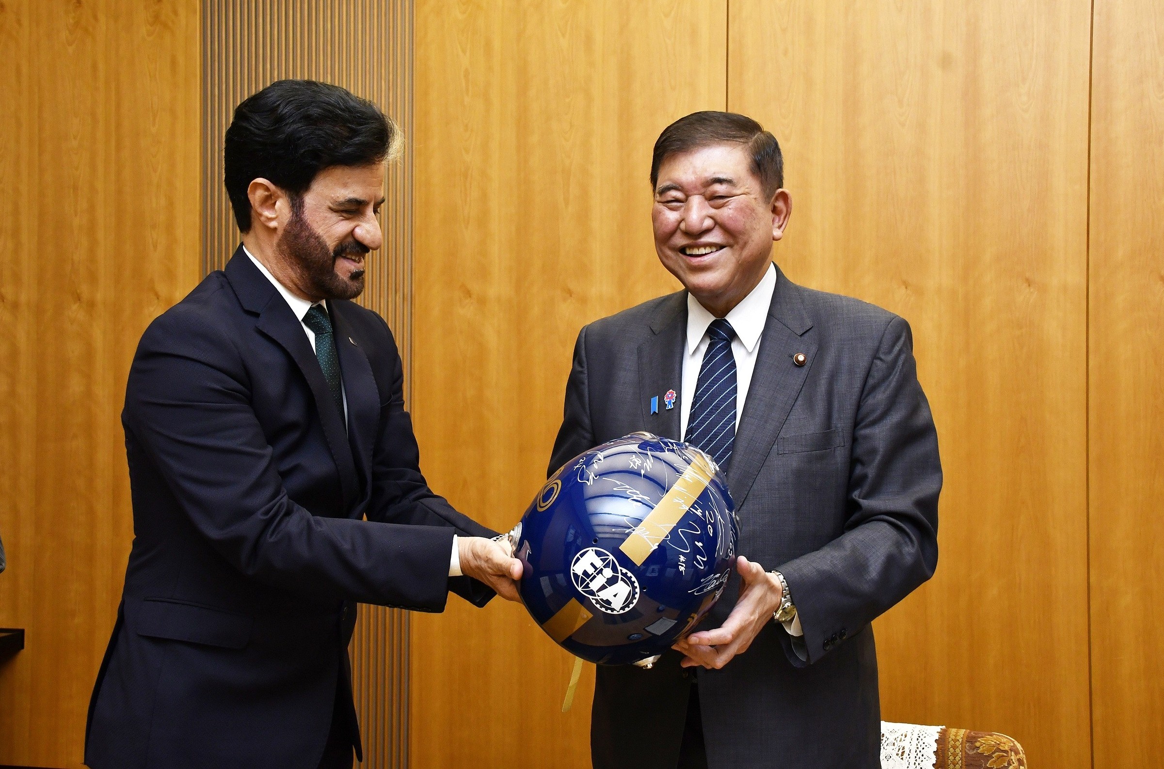 1. FIA President Mohammed Ben Sulayem presents Japanese Prime Minister Shigeru Ishiba with a commemorative FIA race helmet signed by all of last