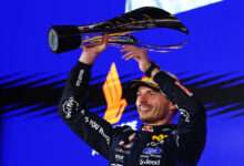 SINGAPORE, SINGAPORE - OCTOBER 11: Race winner Max Verstappen of the Netherlands and Oracle Red Bull Racing lifts his trophy on the podium during the F1 Grand Prix of Singapore at Marina Bay Street Circuit on October 11, 2026 in Singapore, Singapore. (Photo by Mark Thompson/Getty Images) // Getty Images / Red Bull Content Pool // SI202610110434 // Usage for editorial use only //